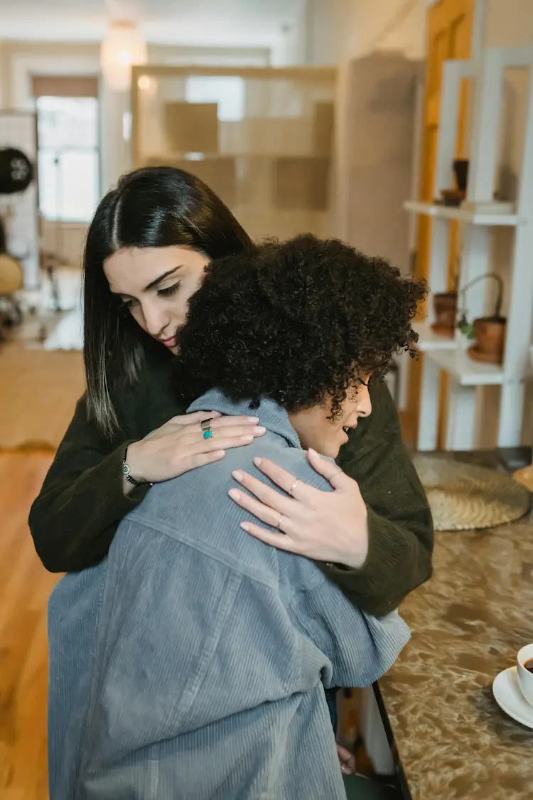 A woman hugging another woman