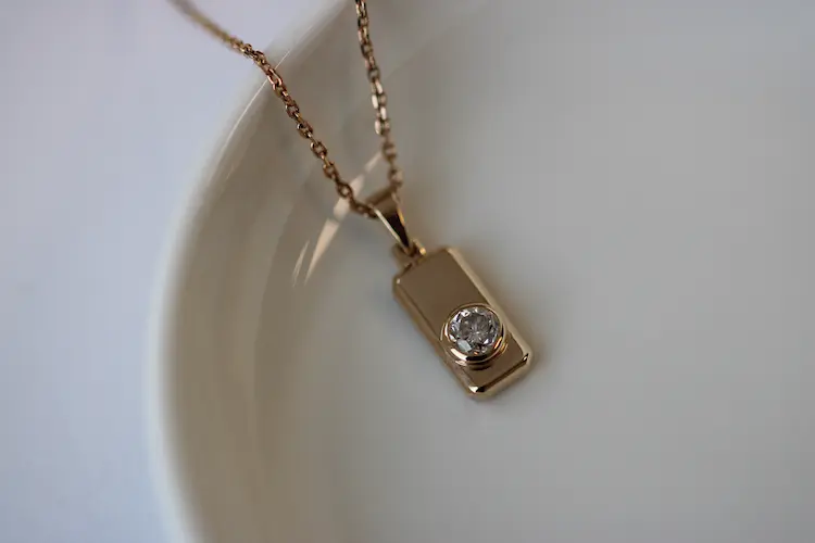 A rectangular pendant with a memorial diamond set in it