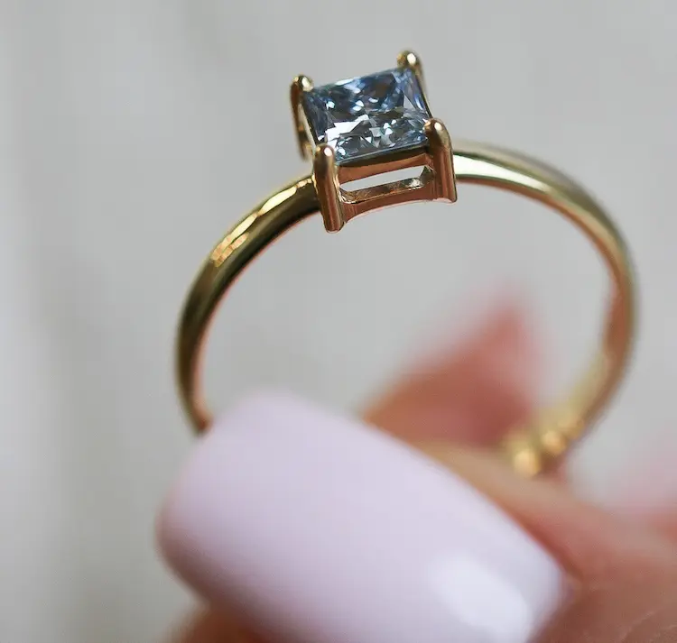 A blue cremation diamond, set in a gold ring.